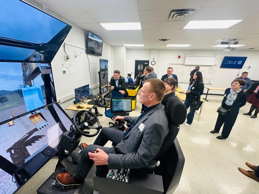 Pukuun pukeutunut henkilö testaa simulaattorilla ajoa. 